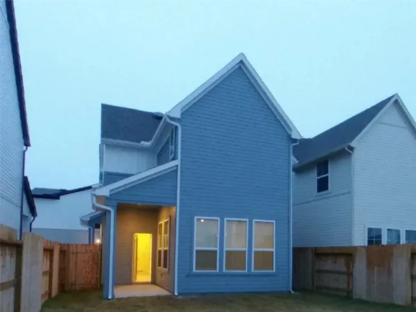 a view of brick house with a small yard