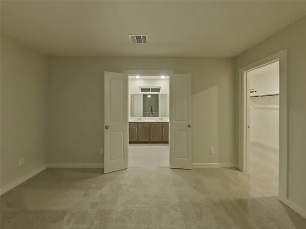 an empty room with kitchen and a sink