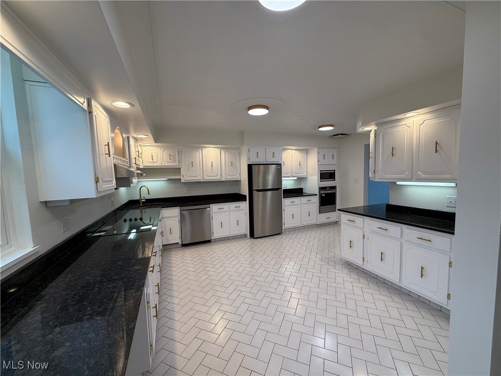 522 North 3rd Street Toronto, OH 43964 - Photo 13 of 47 Kitchen featuring stainless steel appliances, white cabinets, dark stone countertops, and recessed lighting