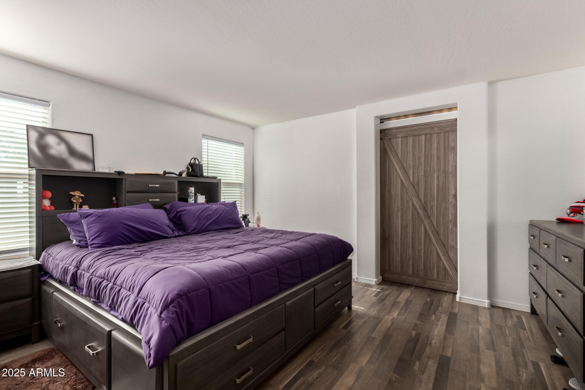 910 Prior Avenue Coolidge, AZ 85128 - Photo 10 of 22 a bedroom with a bed and wooden floor