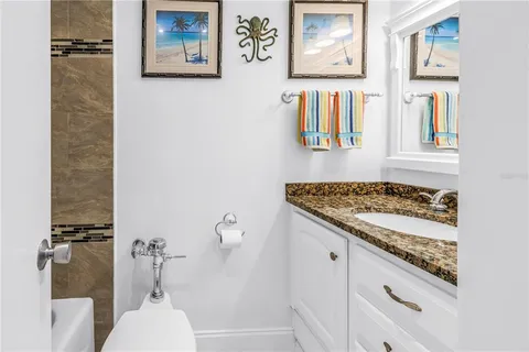 a bathroom with a granite countertop sink and a stove