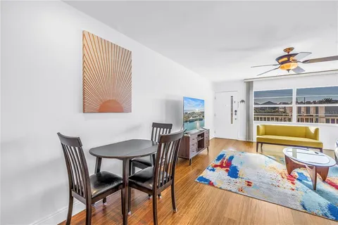 a dining room with furniture and a large window
