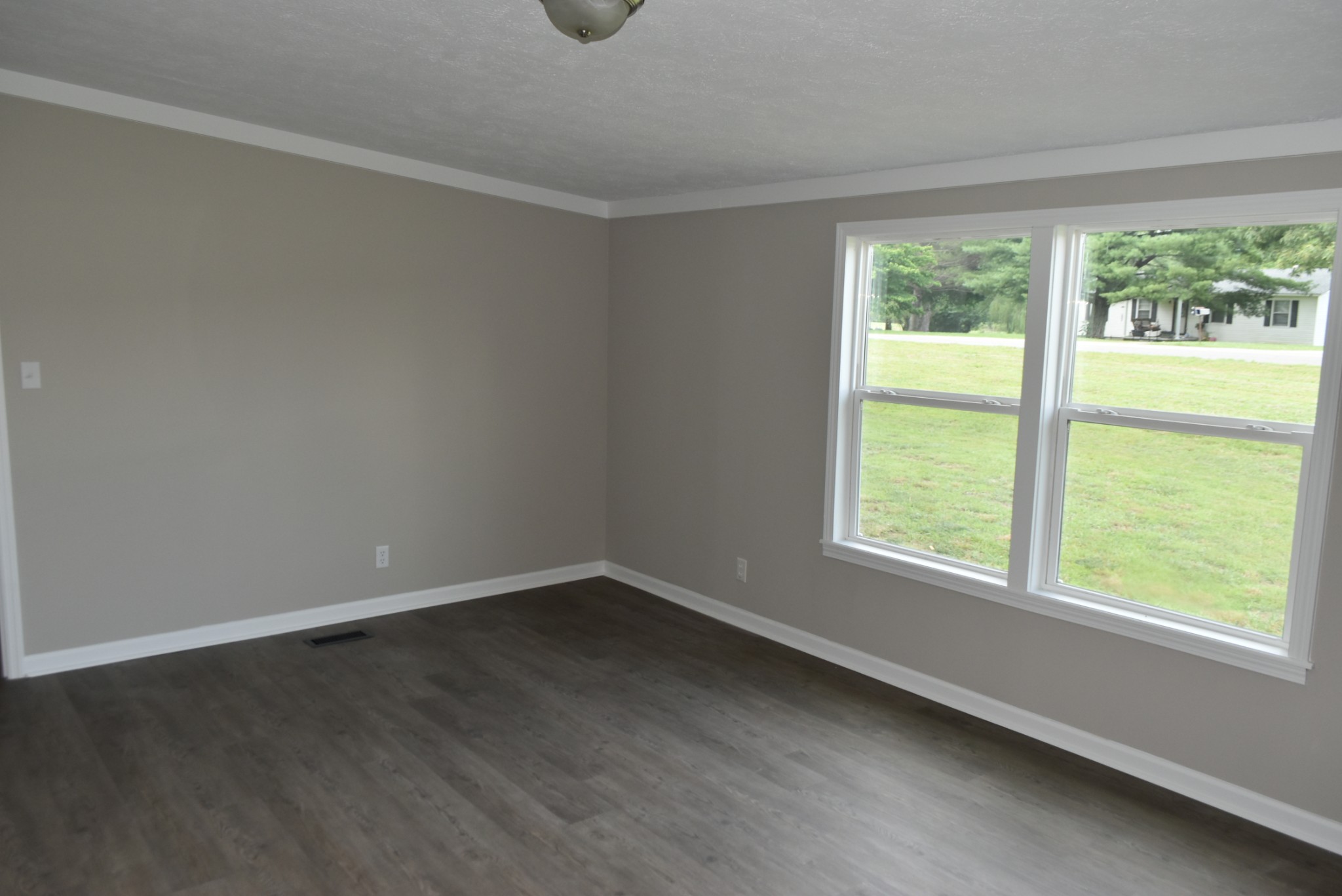 149 Harbin Road Fayetteville, TN 37334 - Photo 7 of 12 a view of an empty room with wooden floor and a window