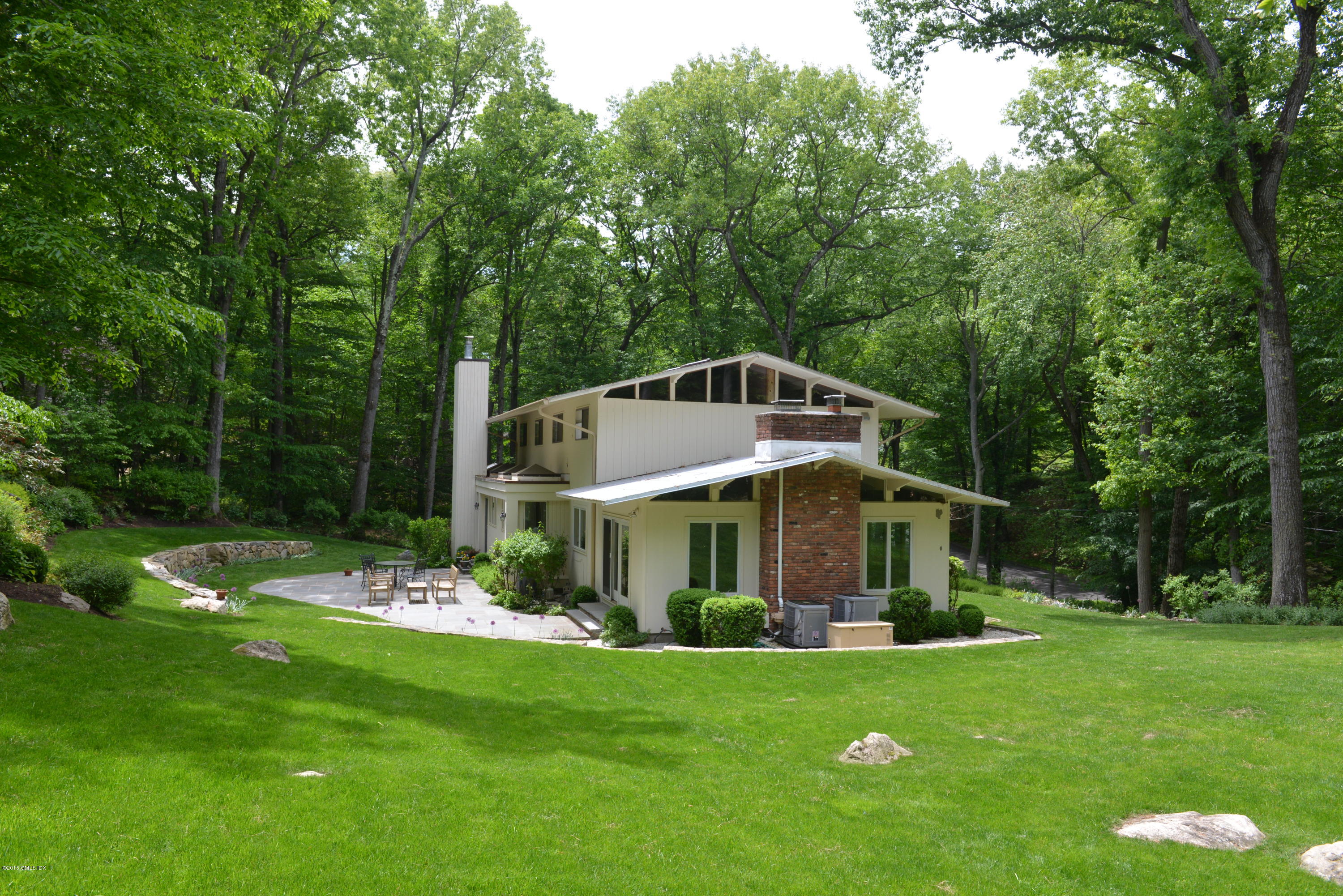 15 Ferncliff Road Cos Cob, CT 06807 - Photo 16 of 16 a front view of a house with a yard table and chairs