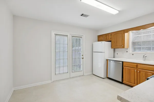 a kitchen with stainless steel appliances granite countertop a refrigerator and a stove top oven