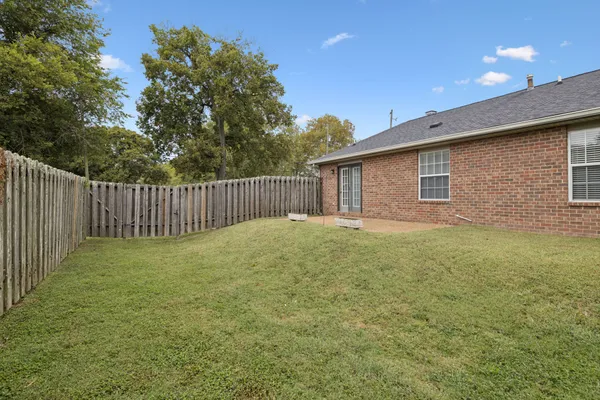 a view of a lake with a bench and trees