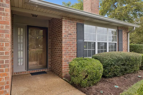 a view of empty room with wooden floor and windows
