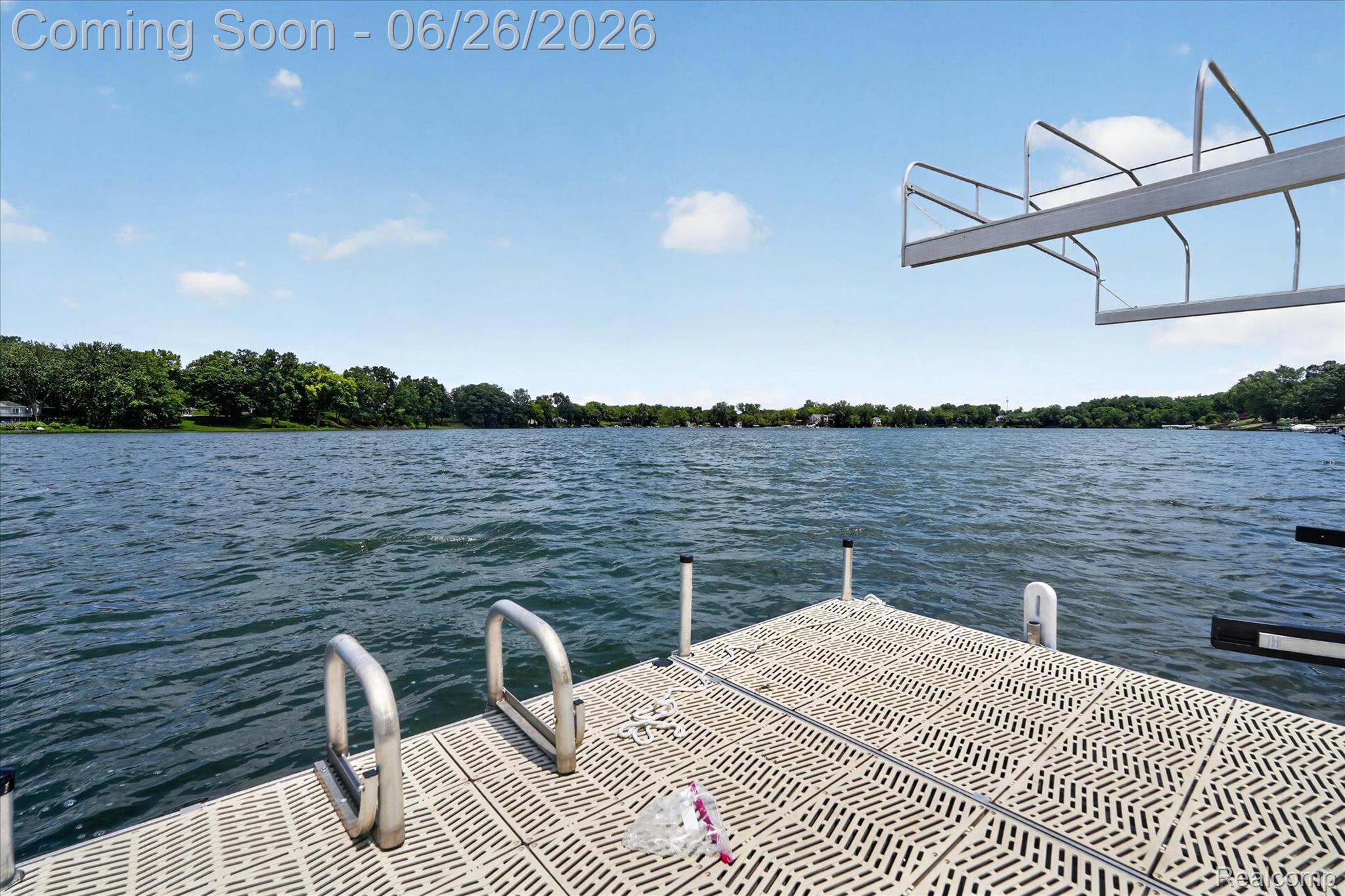 3478 Lexington Road Waterford, MI 48328 - Photo 32 of 52 Waterfront property featuring a durable composite dock with integrated ladder, expansive water frontage, and a boat lift structure