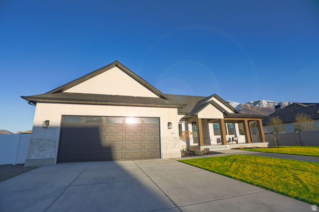 126 North 800 West Mapleton, UT 84664 - Photo 3 of 79 View of front of home featuring stone siding, a porch, an attached garage, and concrete driveway