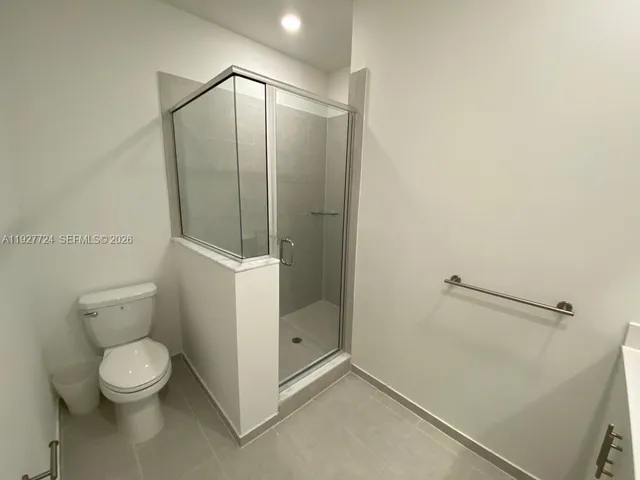 a bathroom with a toilet and a shower