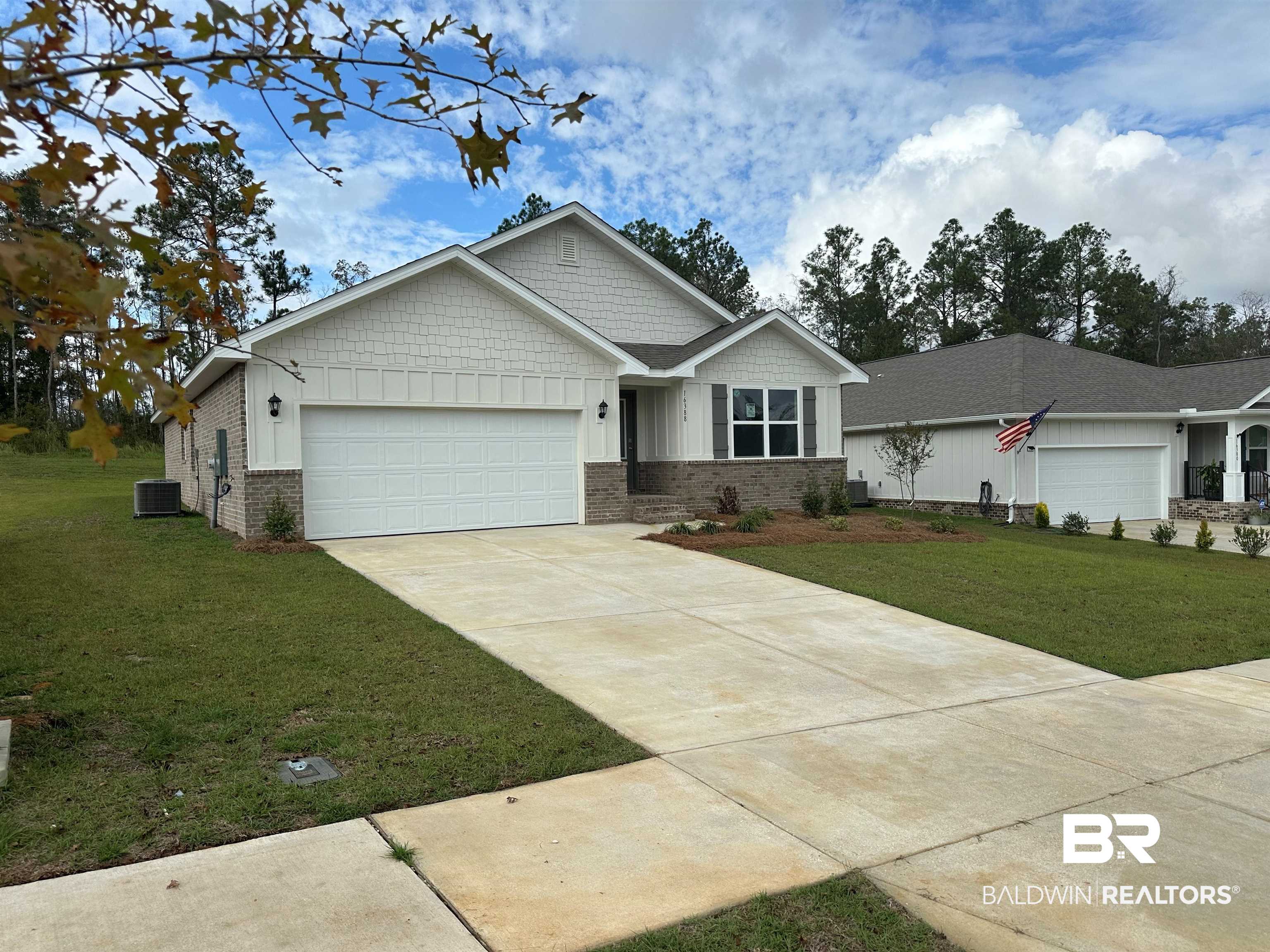 16388 Laurelbrooke Loop, Unit 39 CALI Fairhope, AL 36532 - Photo 1 of 30 View of front facade featuring a garage, central air condition unit, and a front yard