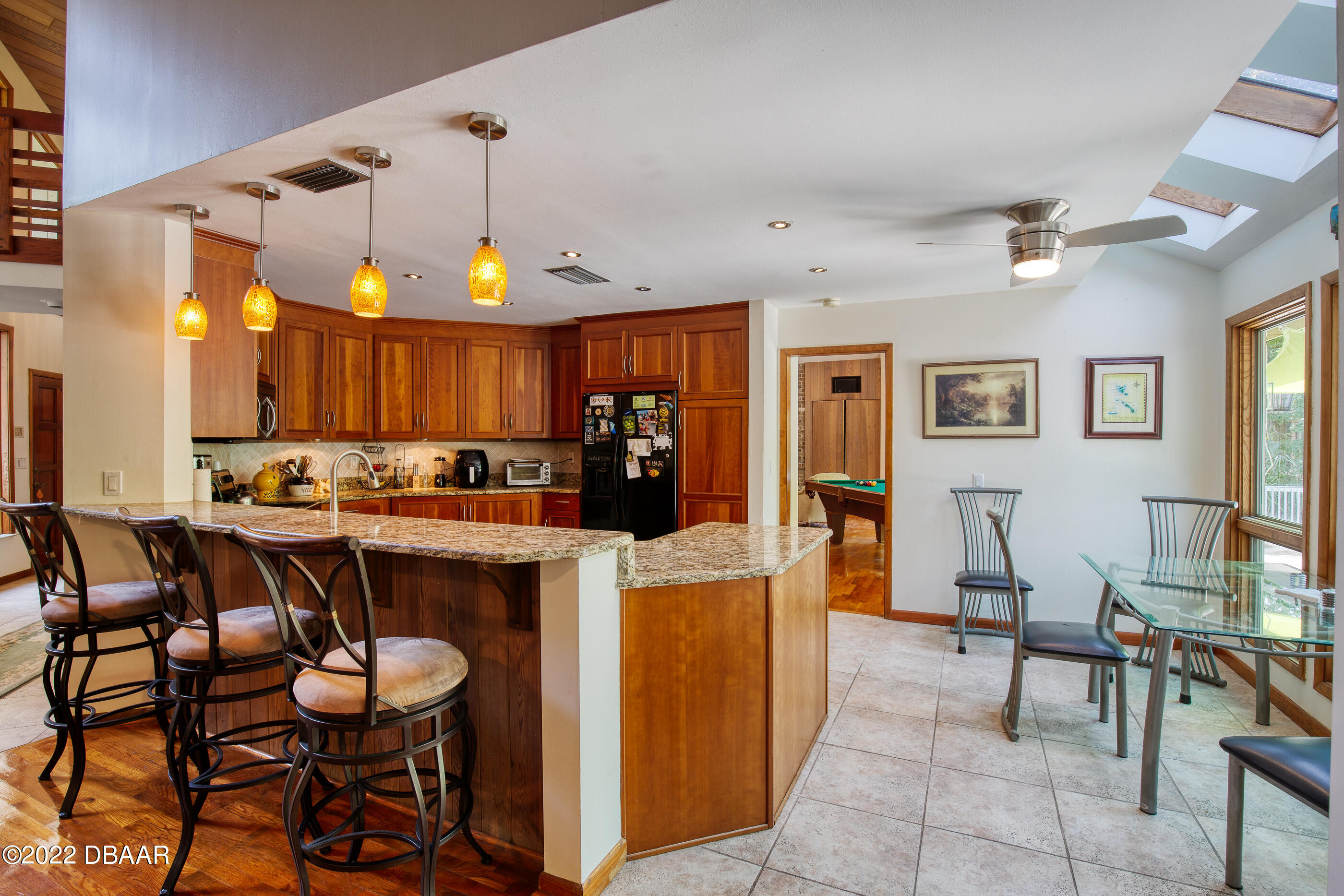 110 River Bluff Drive Ormond Beach, FL 32174 - Photo 20 of 57 a large kitchen with a table and chairs in it