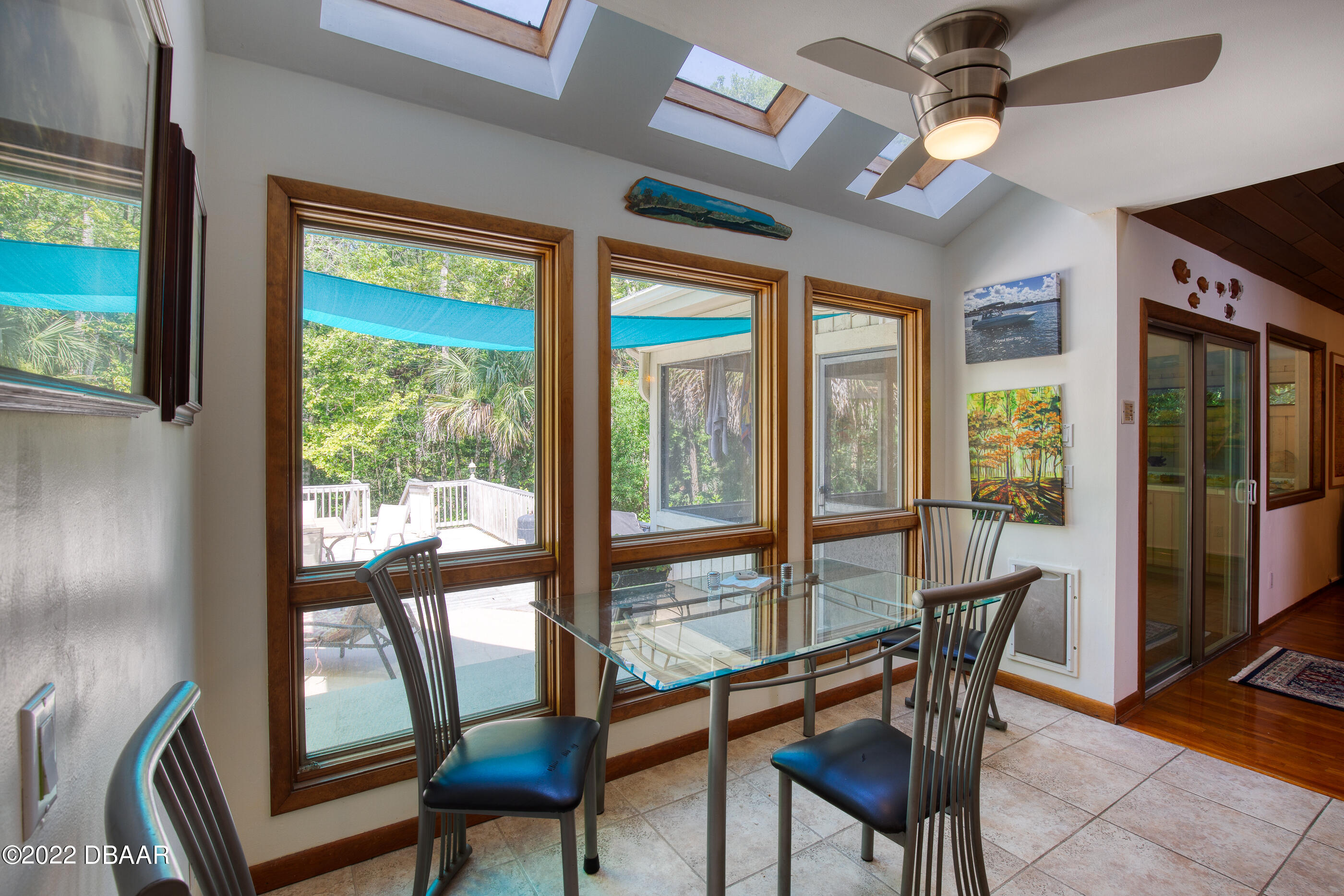110 River Bluff Drive Ormond Beach, FL 32174 - Photo 22 of 57 a view of a dining room with furniture large windows and wooden floor
