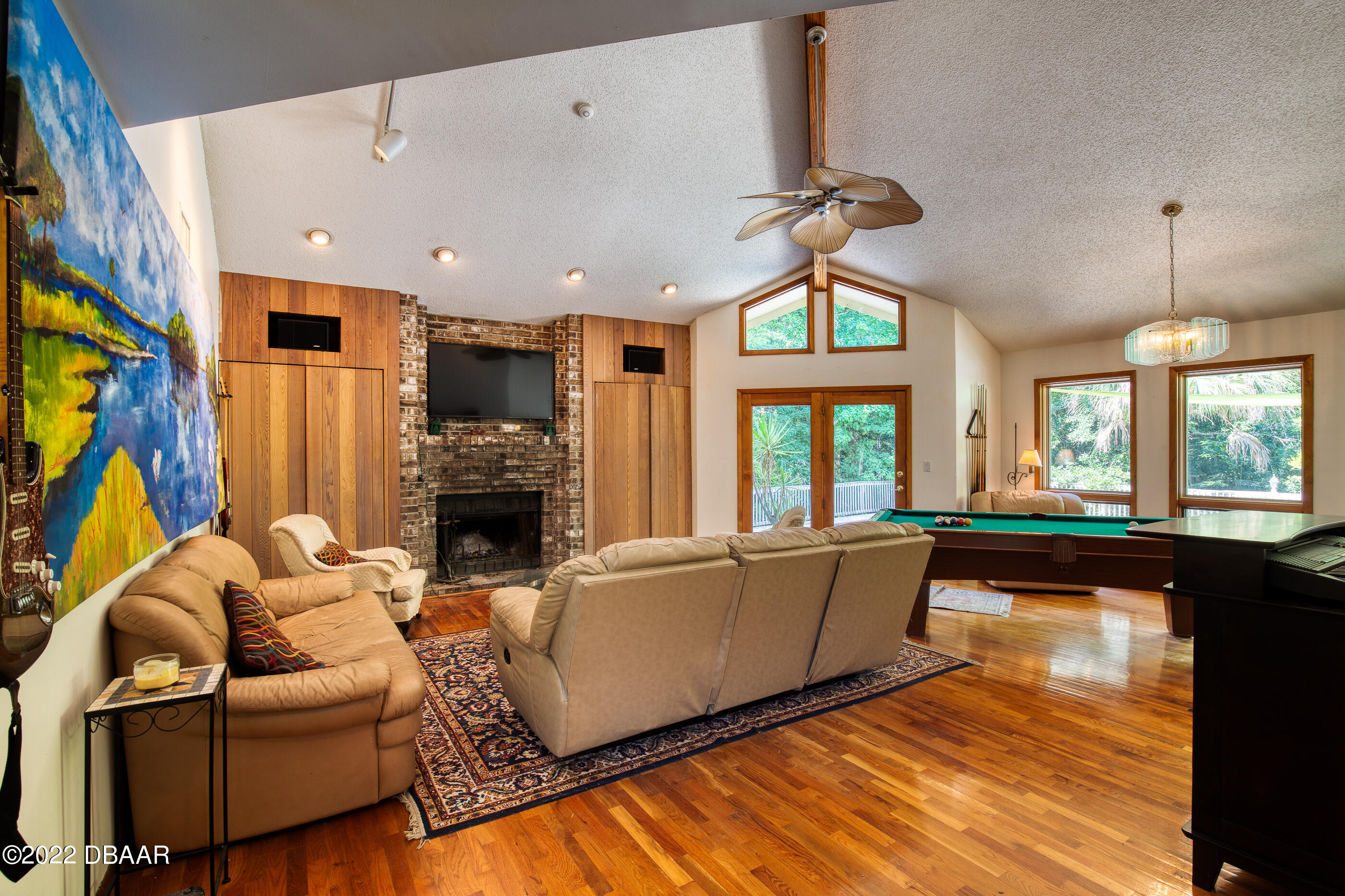 110 River Bluff Drive Ormond Beach, FL 32174 - Photo 27 of 57 a living room with furniture a fireplace and a chandelier