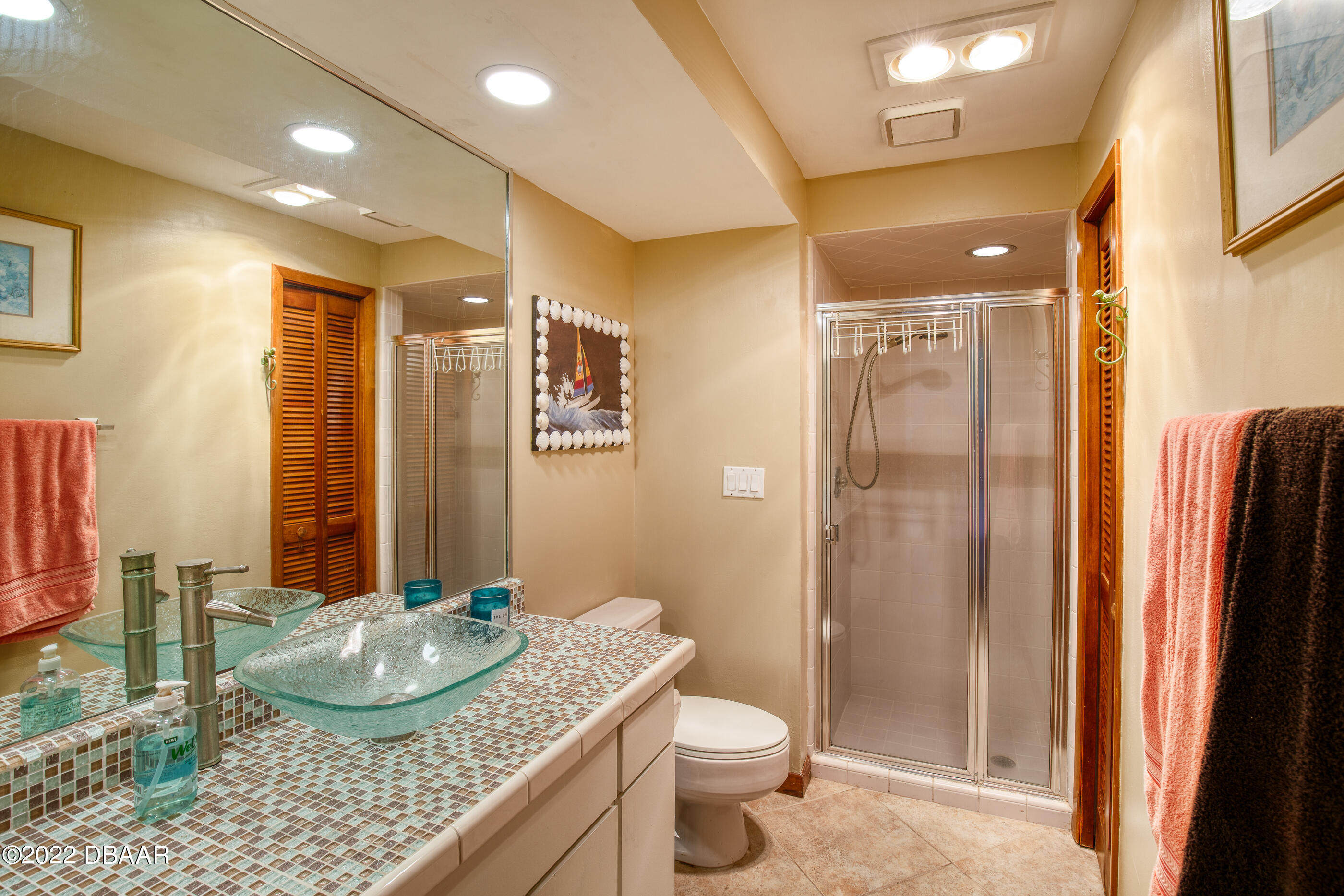 110 River Bluff Drive Ormond Beach, FL 32174 - Photo 28 of 57 a bathroom with a granite countertop sink a toilet a mirror and shower
