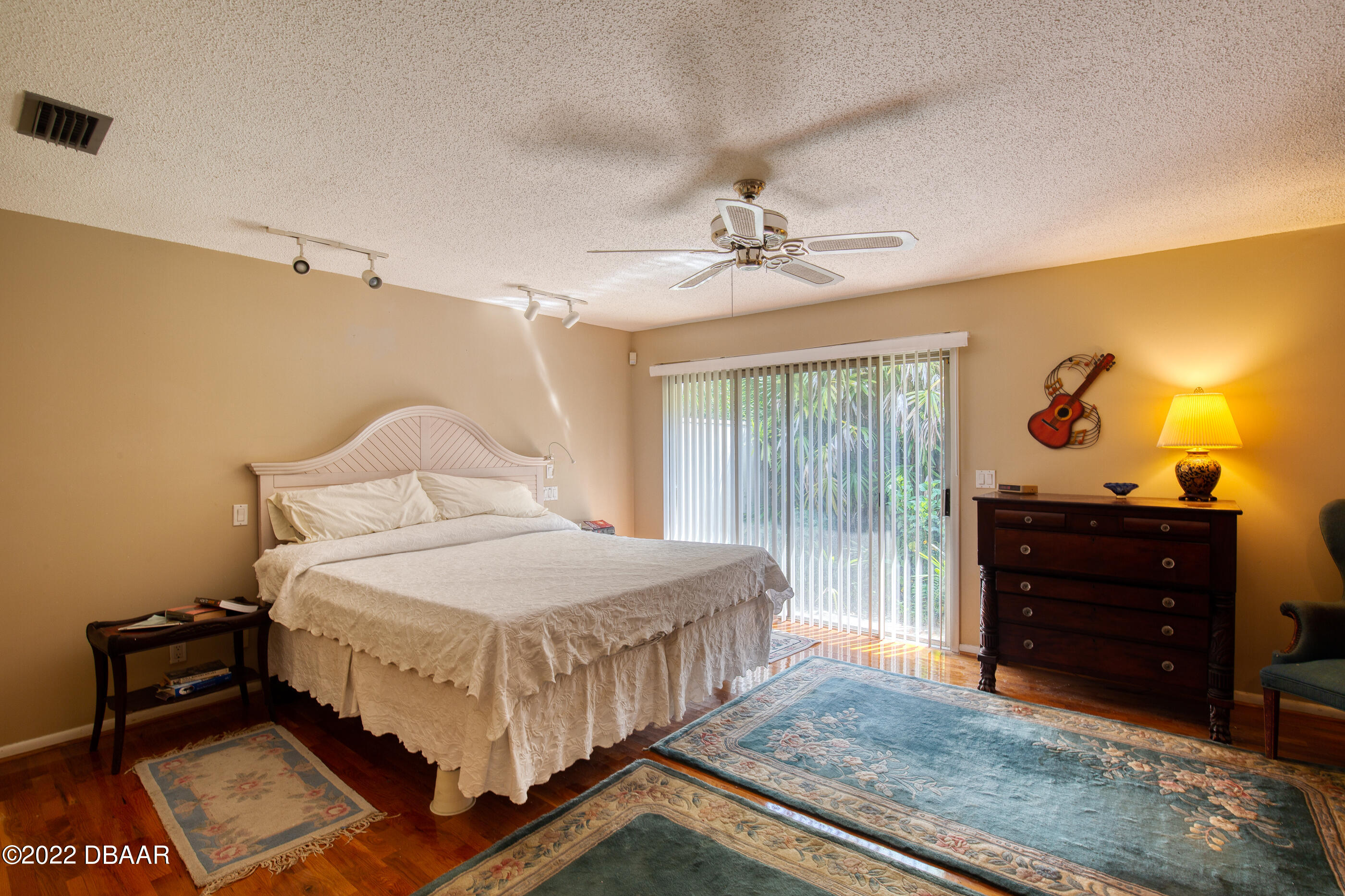110 River Bluff Drive Ormond Beach, FL 32174 - Photo 31 of 57 a bedroom with a bed and a chandelier