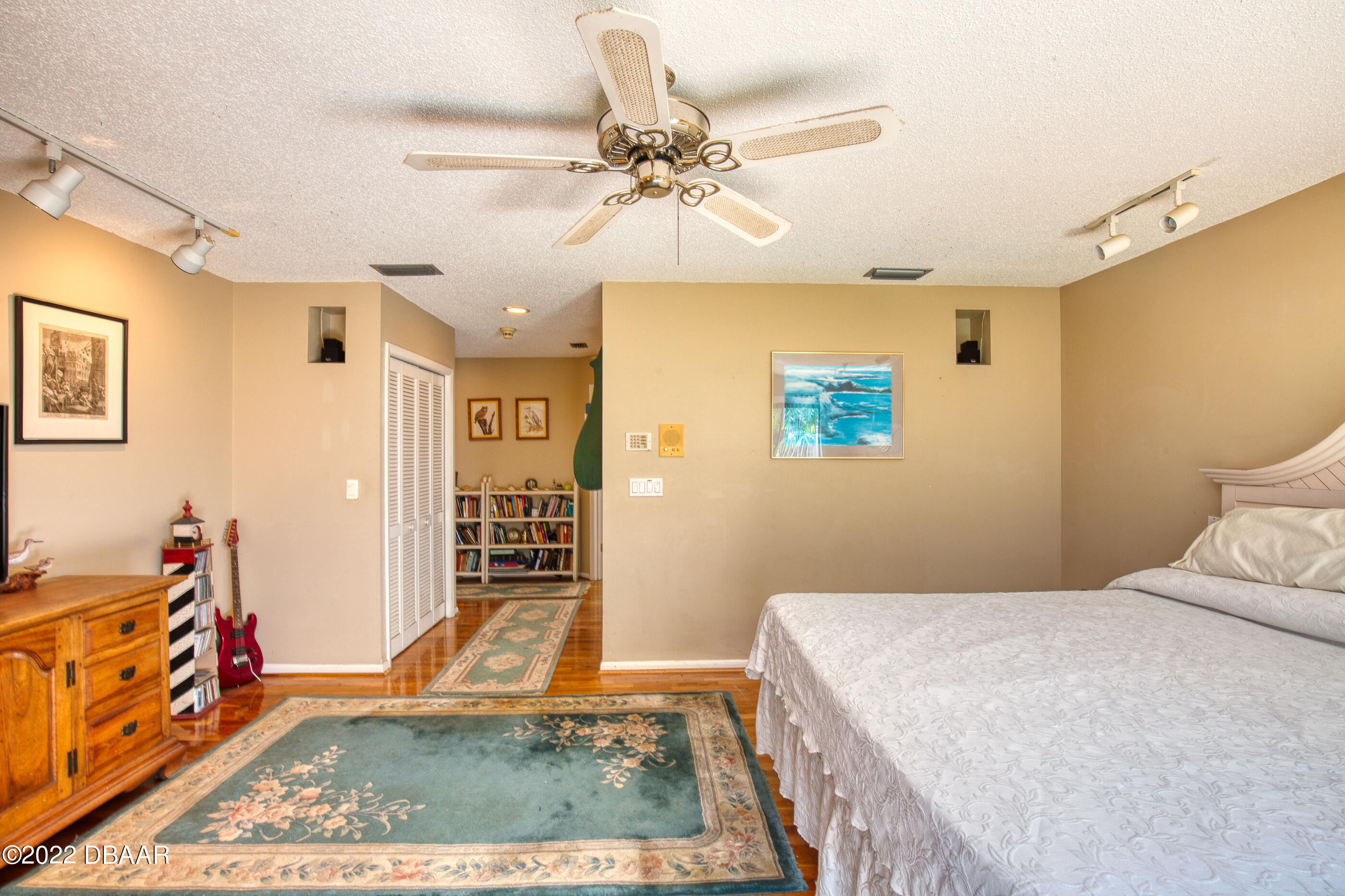 110 River Bluff Drive Ormond Beach, FL 32174 - Photo 32 of 57 a bedroom with a bed and a chandelier