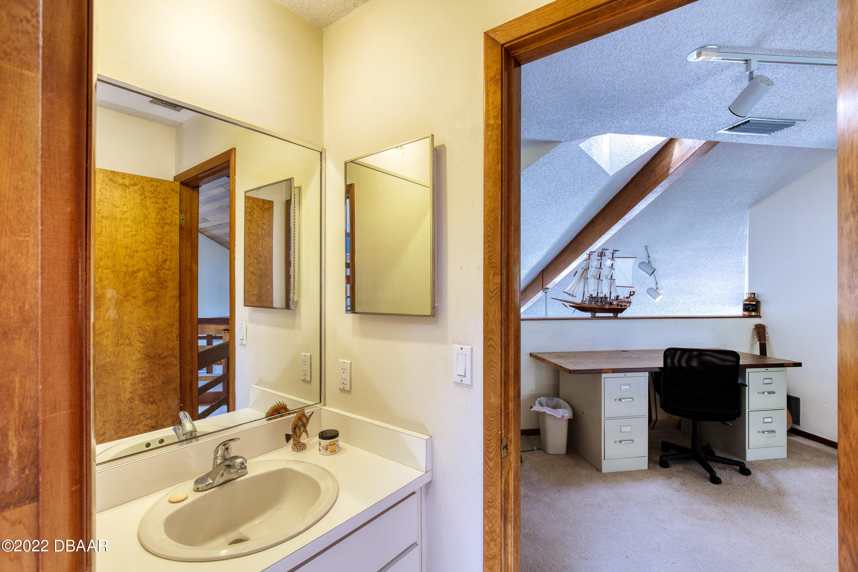 110 River Bluff Drive Ormond Beach, FL 32174 - Photo 43 of 57 a bathroom with a sink and a mirror