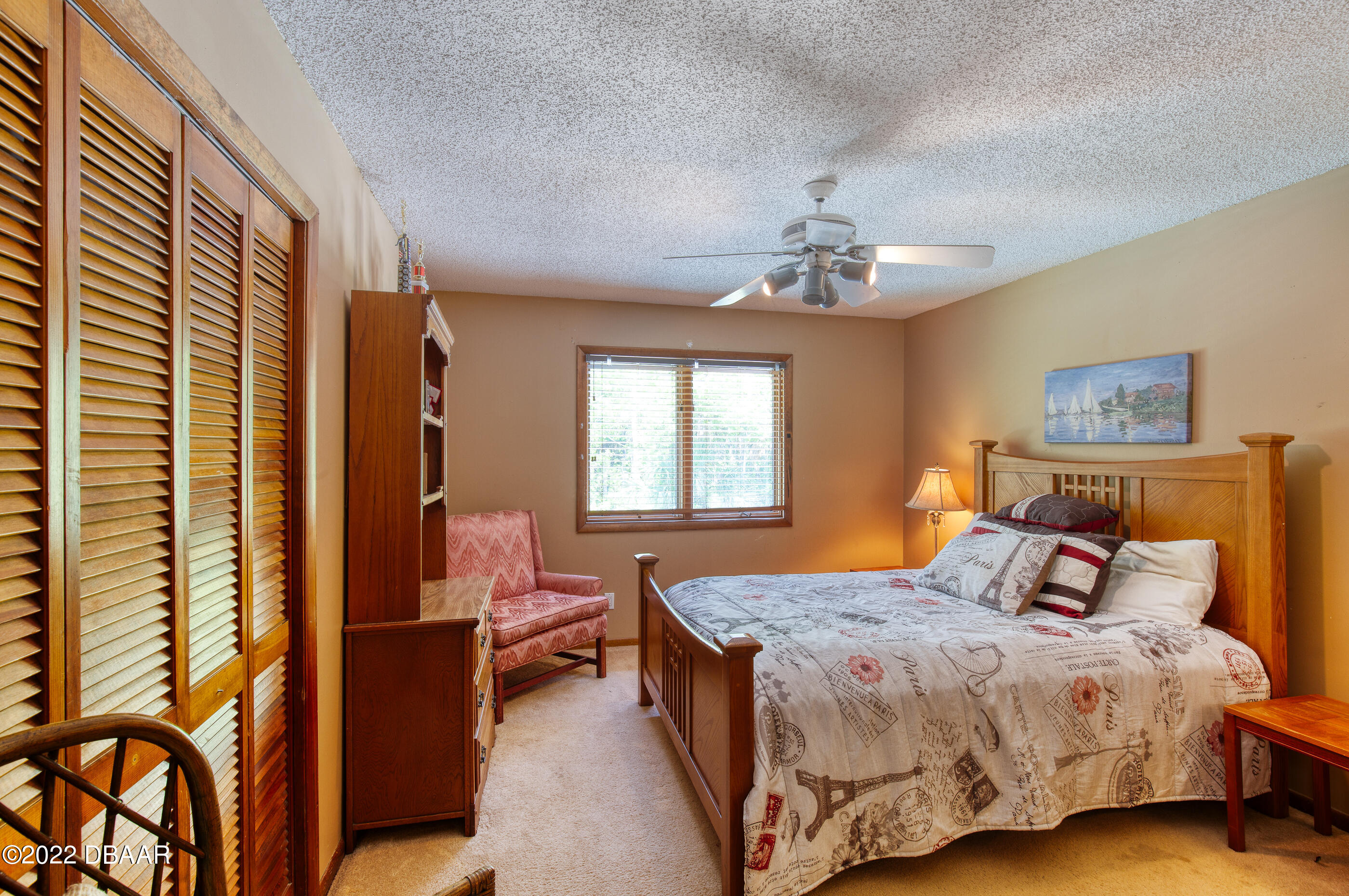 110 River Bluff Drive Ormond Beach, FL 32174 - Photo 44 of 57 a bedroom with a bed and a chandelier