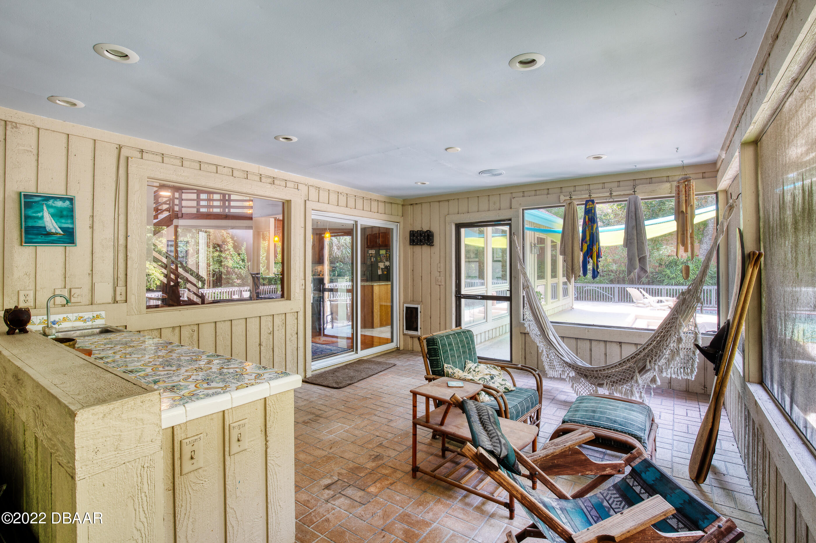 110 River Bluff Drive Ormond Beach, FL 32174 - Photo 47 of 57 a room with furniture and a floor to ceiling window