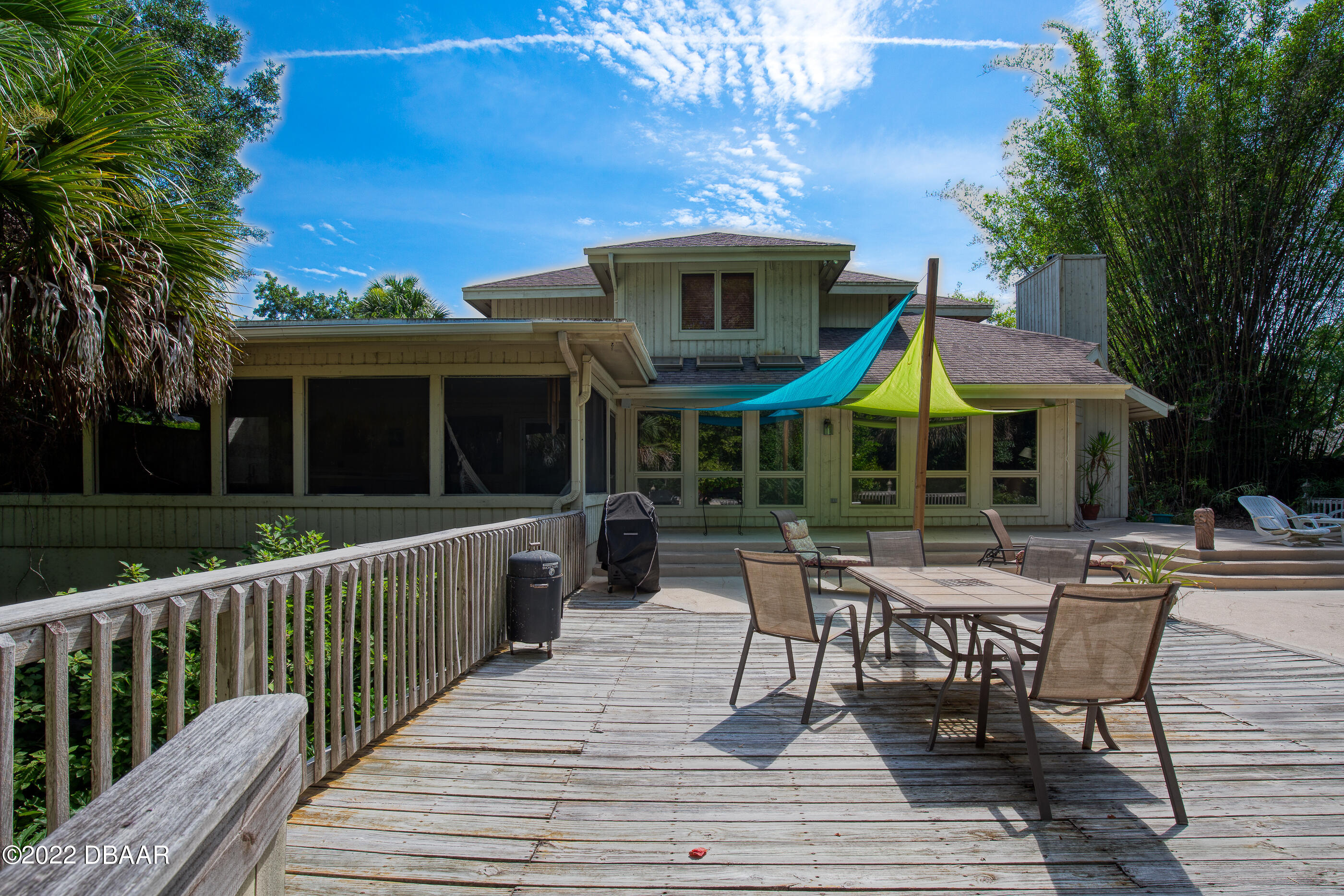 110 River Bluff Drive Ormond Beach, FL 32174 - Photo 48 of 57 a view of a chair and tables in the deck in front of house