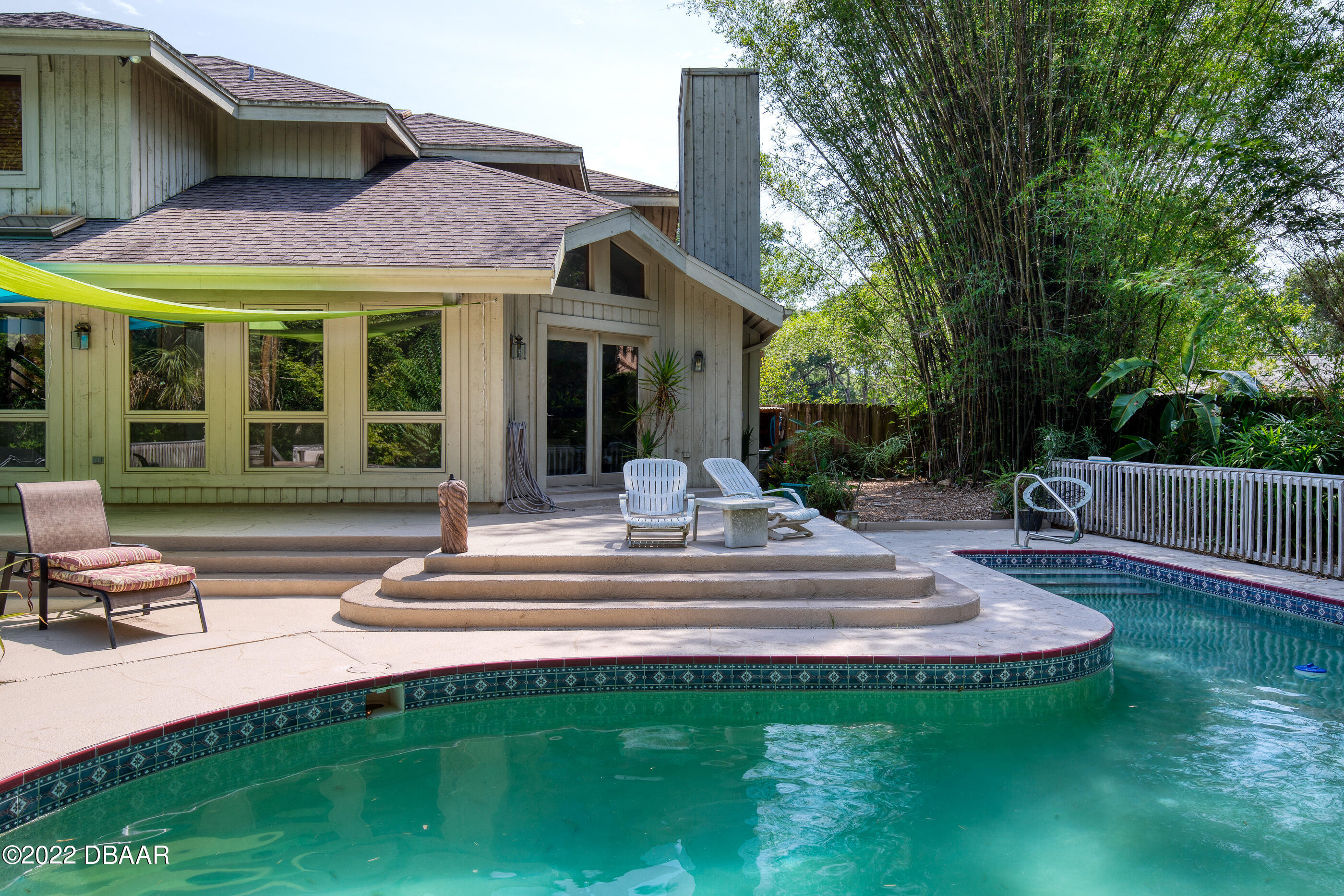 110 River Bluff Drive Ormond Beach, FL 32174 - Photo 51 of 57 a view of a house with a swimming pool and porch with furniture
