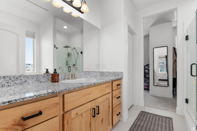 500 North 516th Street West, Unit 19 Mapleton, UT 84664 - Photo 9 of 41 Bathroom vanity featuring light-toned wood cabinetry, stone-finish countertop, and a single undermount sink
