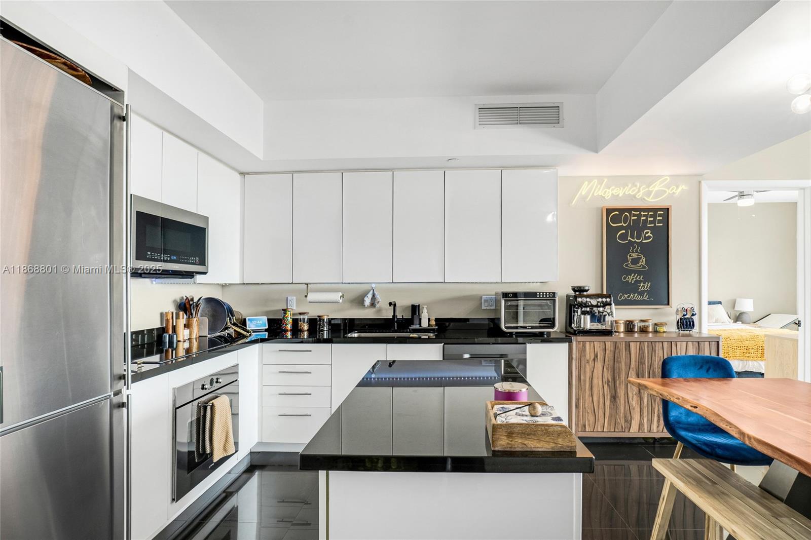 92 Southwest 3rd Street, Unit 4312 Miami, FL 33130 - Photo 6 of 20 a kitchen with stainless steel appliances granite countertop a stove top oven a sink dishwasher and cabinets with wooden floor