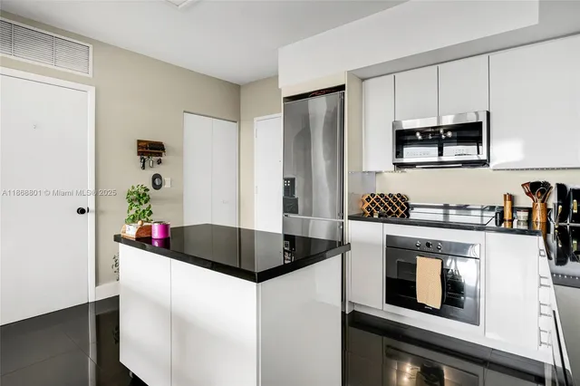 a kitchen with stainless steel appliances granite countertop a stove and a microwave