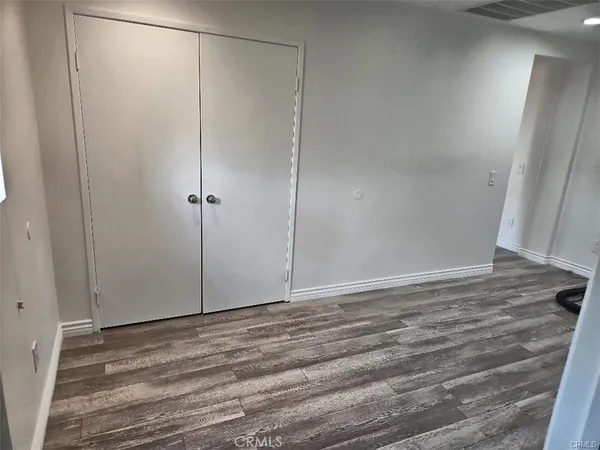 a view of a room with wooden floor