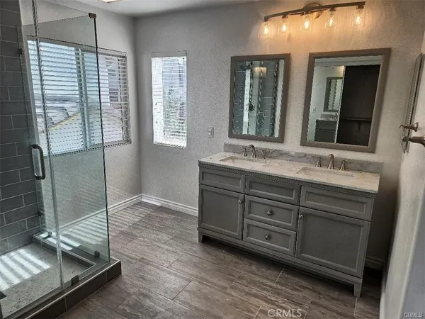 a bathroom with a double vanity sink mirror and window