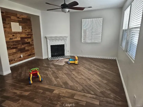 a view of empty room with fireplace and windows