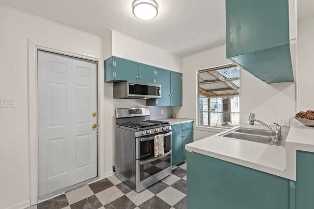 a kitchen with a sink appliances and cabinets