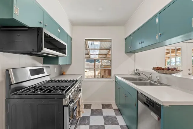 a kitchen with a stove and a sink