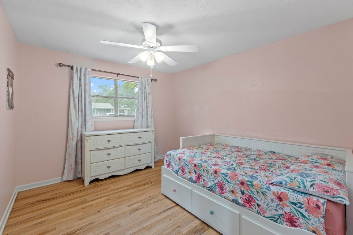 1805 Vine Street Georgetown, TX 78626 - Photo 14 of 32 a bedroom with a bed and a chandelier