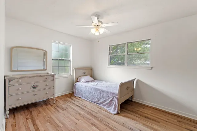 a bedroom with a bed and a dresser