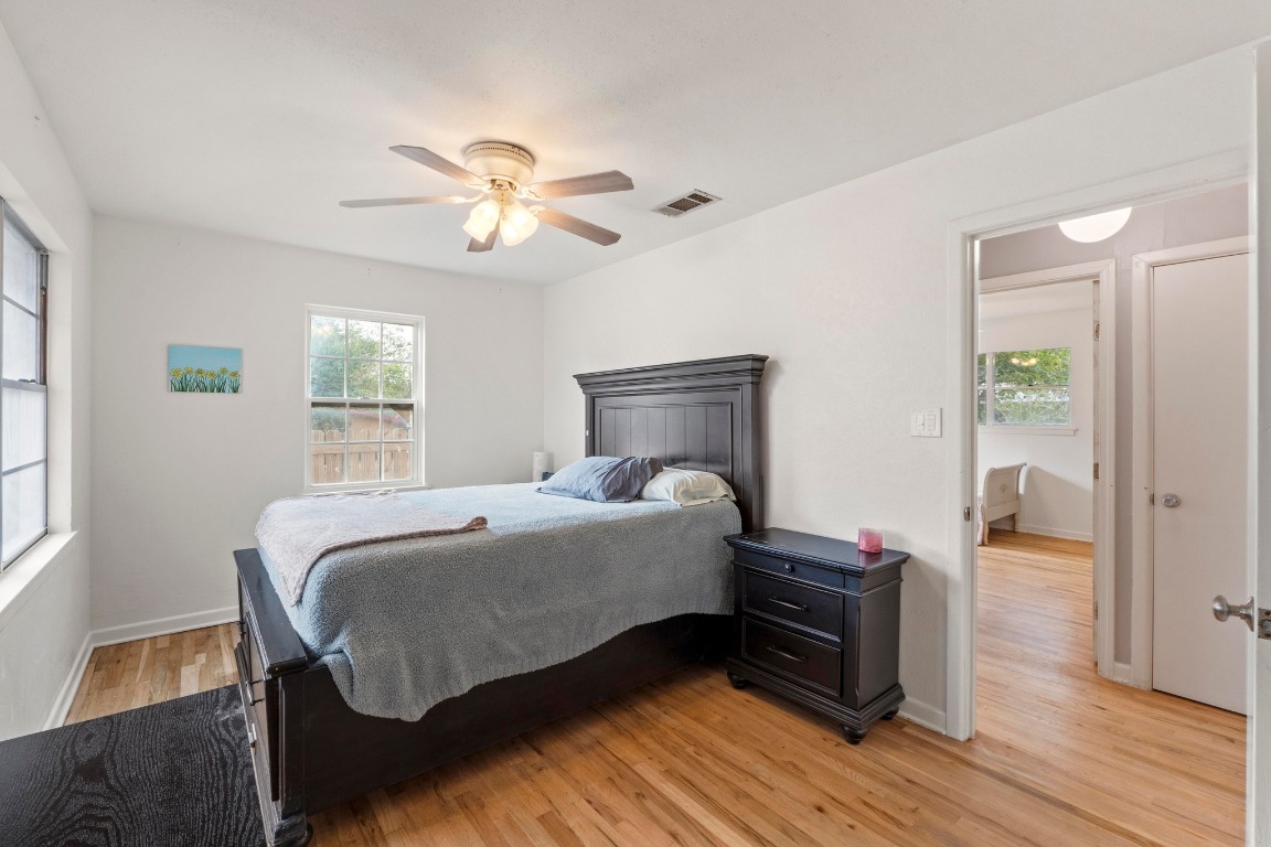 1805 Vine Street Georgetown, TX 78626 - Photo 18 of 32 a bedroom with a bed and wooden floor
