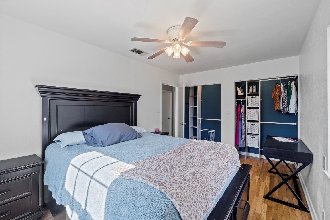 1805 Vine Street Georgetown, TX 78626 - Photo 19 of 32 a bedroom with a large bed and a chandelier