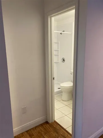 a view of a yard next to a large tree