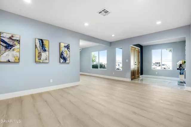 a kitchen with stainless steel appliances a refrigerator sink and white cabinets
