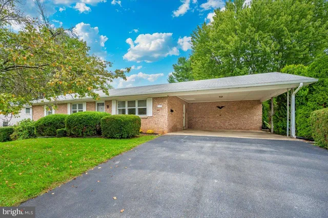 a view of a house with a yard and potted plants