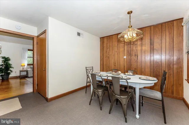 a view of a dining room with furniture and chandelier
