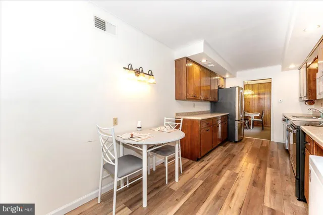 a view of a room with wooden floor and a window