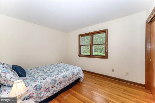 a bedroom with a large bed and curtain