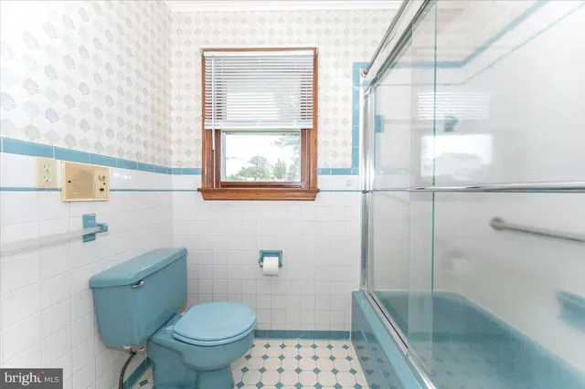 a bed room with a bed and a chair