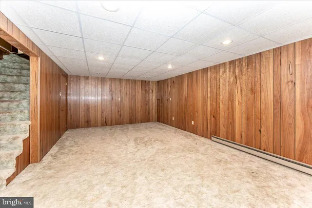 a view of a room with furniture and a ceiling fan
