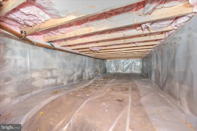 a house is sitting in middle of the green field