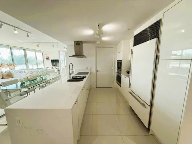 a kitchen with stainless steel appliances a refrigerator and a stove