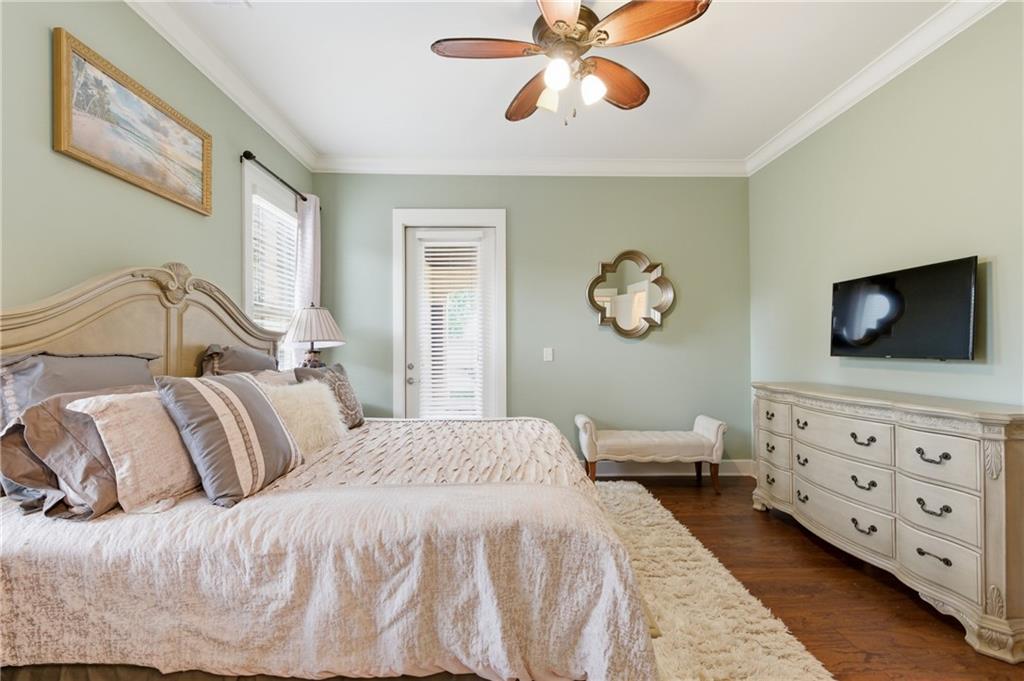 117 South Bay Road, Unit 402 Eatonton, GA 31024 - Photo 20 of 48 a bedroom with a large bed and a flat tv screen on dresser