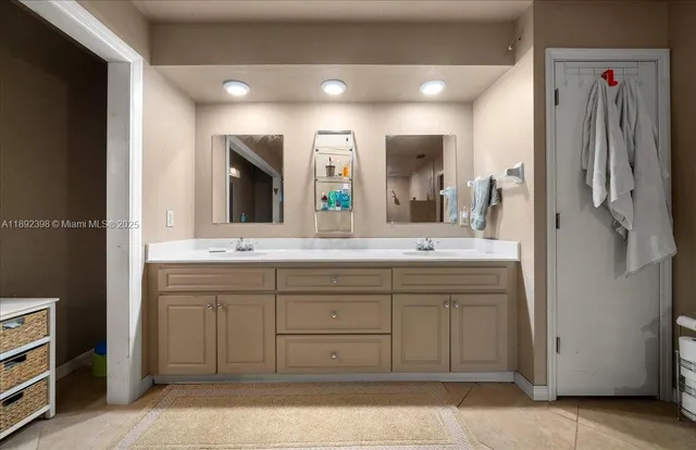 a bathroom with a double vanity sink and a mirror